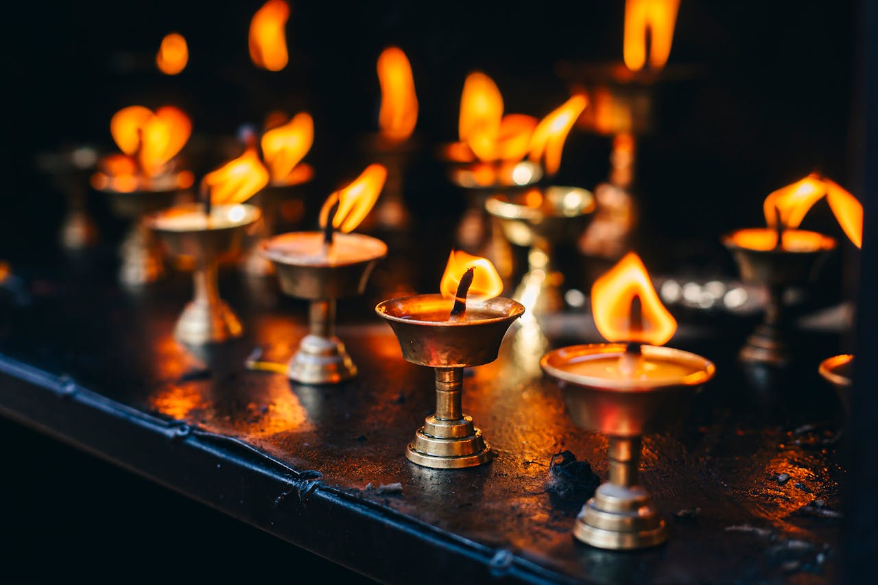 Mastering the First Impression: Your intriguing post title goes here Warm glowing oil lamps in brass holders, symbolizing light and spirituality.